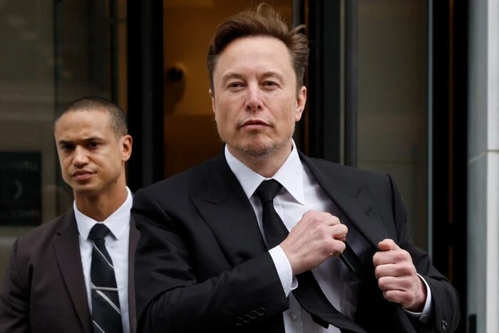 Musk talks to reporters at the White House